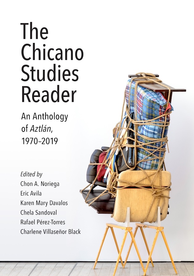 The Chicano Studies Reader white and tan book cover showing a stack of chairs and other household items tied together with a rope.
