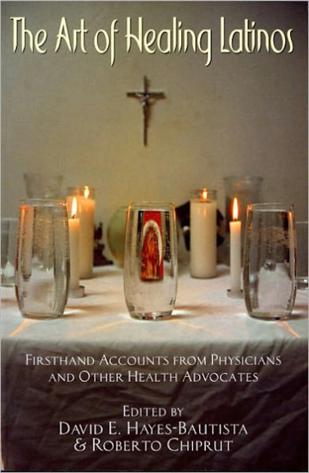 Book cover with lit candles, glasses of water, a religious card, and a cross, with the title in yellow text.