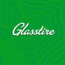 Glasstire logo in white cursive text on a green patterned background.
