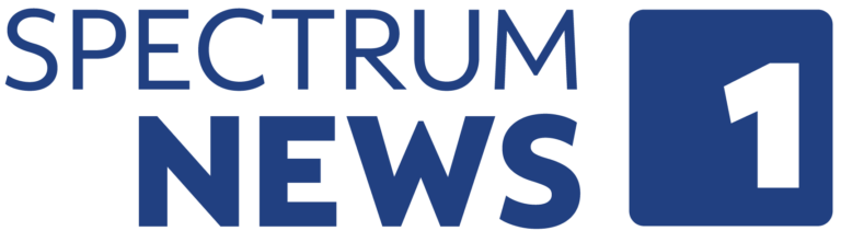 Spectrum News 1 logo in blue text on a light grey background.